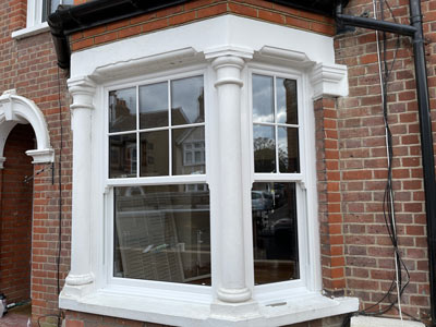 window with white frames and columns