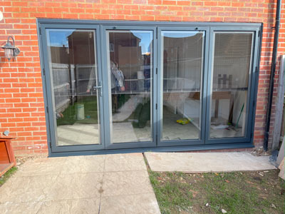 modern glass extension with five large windows open to backyard area