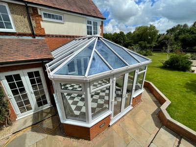 glass conservatory with checkered floor and garden outside