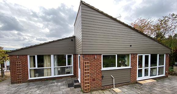 modern exterior of a house with brick and featuring large windows 