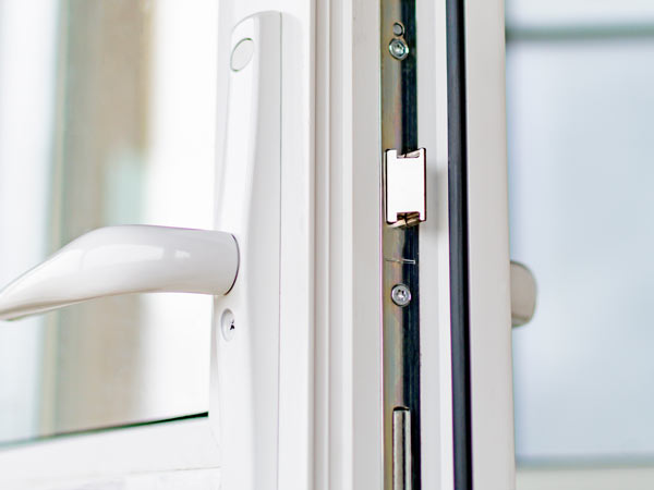 close-up of a white window handle and latch mechanism