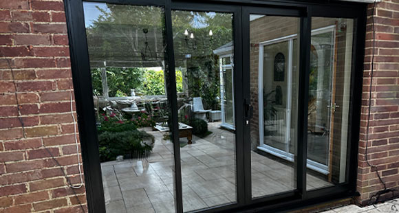 black sliding doors view of patio and garden